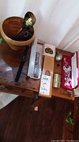 Full lot showing pipes, watch, several jewelry pieces, pen holder, and case on wooden surface