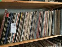 Shelf of classical record albums showing upright vinyl records with visible titles including "Tchaikovsky Karajan" and others.