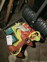 Overhead view of bin top contents showing lunchboxes, plastic horse, plastic vehicle and tag