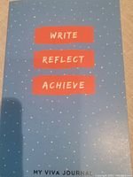 Front cover of the journal showing the title 'Write Reflect Achieve - My Viva Journal' with a blue cover and small white dots