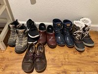 Photo showing all six pairs of women's shoes including hiking boots, gym shoes, loafers, and rain boots.