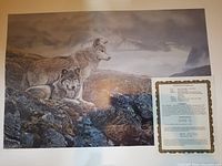 Photo showing the print with two gray wolves above timberline in rocky mountainous setting, alongside Certificate of Authenticity.