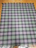 Full view of the wool blend tartan throw blanket showing check pattern and fringed ends.