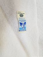 Close-up of Kenwood label showing pure virgin wool content.