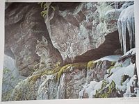 Full view of the wildlife print depicting a bobcat on a rocky snowy cliff with surrounding foliage and icicles.