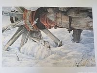Full view of the signed limited edition print showing a snowshoe hare under a wagon wheel in the snow