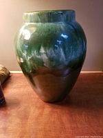 Front view of the vintage oil glaze ceramic vase showing green to brown glaze gradient and glossy finish.