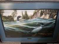 Full view of the framed print showing the two loons in water with pine trees and rocks in the background.
