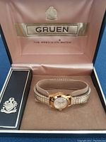 The Gruen branded box containing the vintage women's watch packed with a protective cushion and booklet box.