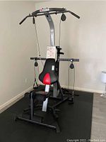 Full view of Bowflex Xceed home gym assembled on exercise mat