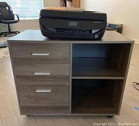 Front view of the wood-finished cabinet with three drawers on the left and two shelves on the right, on caster wheels. HP printer placed on top.