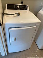 Front exterior view, door closed, power cord draped over top.