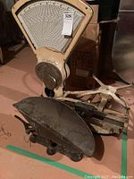 Photo showing the large butcher's scale with cream color and large dial, also showing the hardware scale in front.