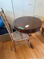 View of table and chair together on wooden floor showing overall condition and structure