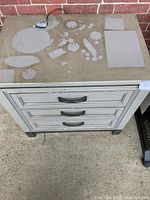 Front and top view of the matte gray Aspen-Liv360 2 drawer nightstand showing visible smoke damage and surface stains.