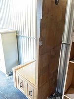 Full side view of the oak desk top section showing two file drawers at the bottom and wooden top with visible wear and scratches.