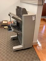 Side and front angle view of the Canon sorter attachment showing overall structure and multiple trays.