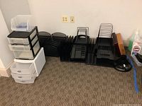 Lot shown on floor with multiple plastic storage drawers, black file holders, and desk trays.