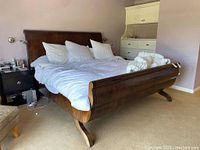 Full view of walnut king sleigh bed frame assembled in room