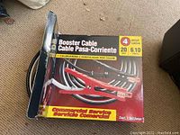 Photo of booster cable box illustrating 4 gauge, 20 ft cables, color-coded, commercial service