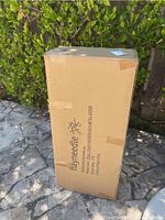 Cardboard box packaging showing Hayneedle branding and product name Coral Coast Chevron Arch Metal Arbor