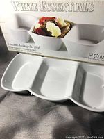 Photo of the White Essentials 3-section rectangular dish alongside its original box showing the product name and features.