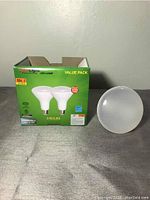 Full box and single bulb displayed showing GreenLight LED Lamp packaging and bulb appearance.