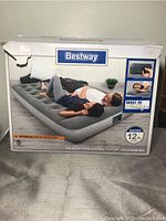 Box of Bestway queen size air mattress showing product image and information about built-in pump and 12 inch height.