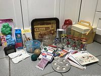 Full view showing Coca-Cola glasses, vintage kitchen items, blue basket, fabric dyes, and other collectibles