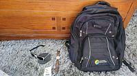 Photo of the backpack, wristwatch, and sunglasses together showing size and condition