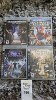Four Playstation 3 video game cases with visible cover art and titles: Transformers The Game, Marvel Ultimate Alliance, Star Wars The Force Unleashed, Lord of the Rings Conquest.