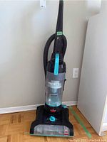 Full front view of Bissell PowerForce vacuum showing upright handle, hose attachment and dust bin.