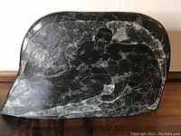 Photo of carved soapstone side featuring detailed engraving of a polar bear.