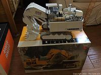 Front/side view of white Liebherr 996 model sitting on its original box