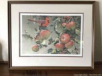Full front view of framed artwork depicting a cardinal bird among wild apples on branches. Shows overall presentation, frame, and matting.
