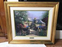 Full front view of framed print showing gold frame, mat, image and title plaque