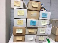 Stack of 14 boxes labeled by year and brand of baseball card sets including 1988 Leaf, 1990 Topps, 1993 Pinnacle, 1994 Triple Play, etc.