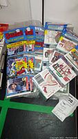 23 sealed packs of Donruss baseball puzzle cards stacked on table, some packs stacked vertically and some laid flat, showing front packaging and cards inside plastic.