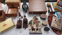 Overview of the duck decoy, wooden boxes, figurines, maracas, and other collectible items arranged on table.