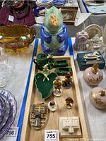 Overview of lot on wooden tray showing pixies, rhino cookie jar, and other porcelain items.
