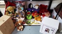 Photo showing multiple plush toys displayed including Muppet Babies and Boyd's Bears in a floral box and on shelf