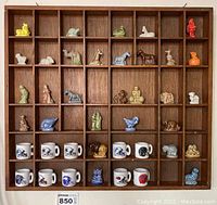 Full view of the wooden shadow box containing 30 Wade Red Rose Tea mini figurines and 10 NFL mini mugs arranged in compartments.