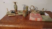 Full view of all marble decor items displayed on a wooden surface including ashtrays, pen holders, vase, and letter opener.