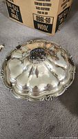 Photo of large ornate covered serving platter, domed lid with decorative finial and scalloped edges