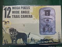 Front of the product box showing 12 Mega Pixels Wide Angle Trail Camera text and lion graphic.
