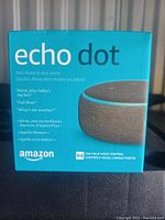 Photo of Amazon Echo Dot packaging front with product name and Alexa branding.