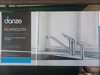 Box of Danze Plymouth single handle kitchen faucet showing model name, features, and installation type.