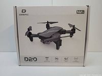 Front view of DeerC D20 drone box showing the drone image and highlighted features including altitude hold, 360 flip, headless mode, and 2.4 GHz communication.