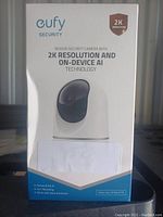 Front view of the Eufy indoor security camera box highlighting 2K resolution and AI technology.