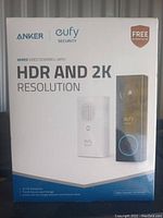 Front side of the product box showing Anker and Eufy branding and highlighting wired video doorbell with HDR and 2K resolution, no monthly fee.